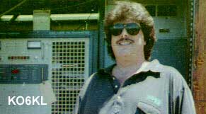 Brad Johnson KO6KL standing near broadcast transmission equipment